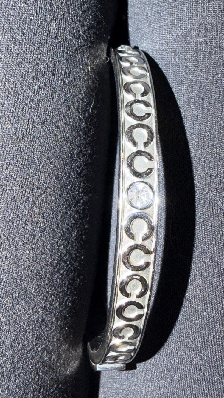 Coach silver tone enamel bangle bracelet with clear rhinestone accent